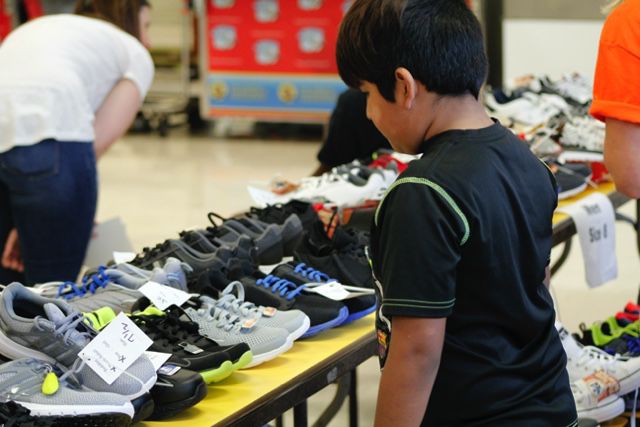 A young boy looking for a special pair of sneakers.JPG